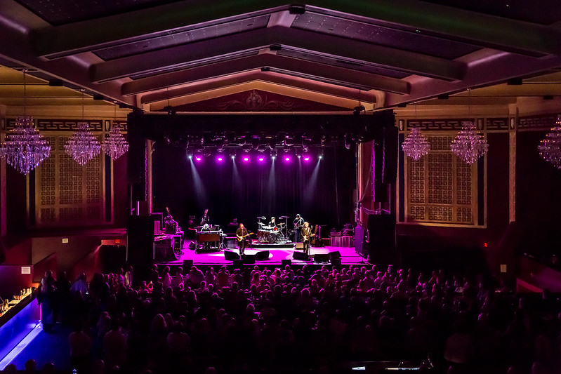 Photo of The Rides Performance. Dark with purple lights and the band on stage