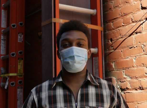 Photo of intern peter deyi with mask on